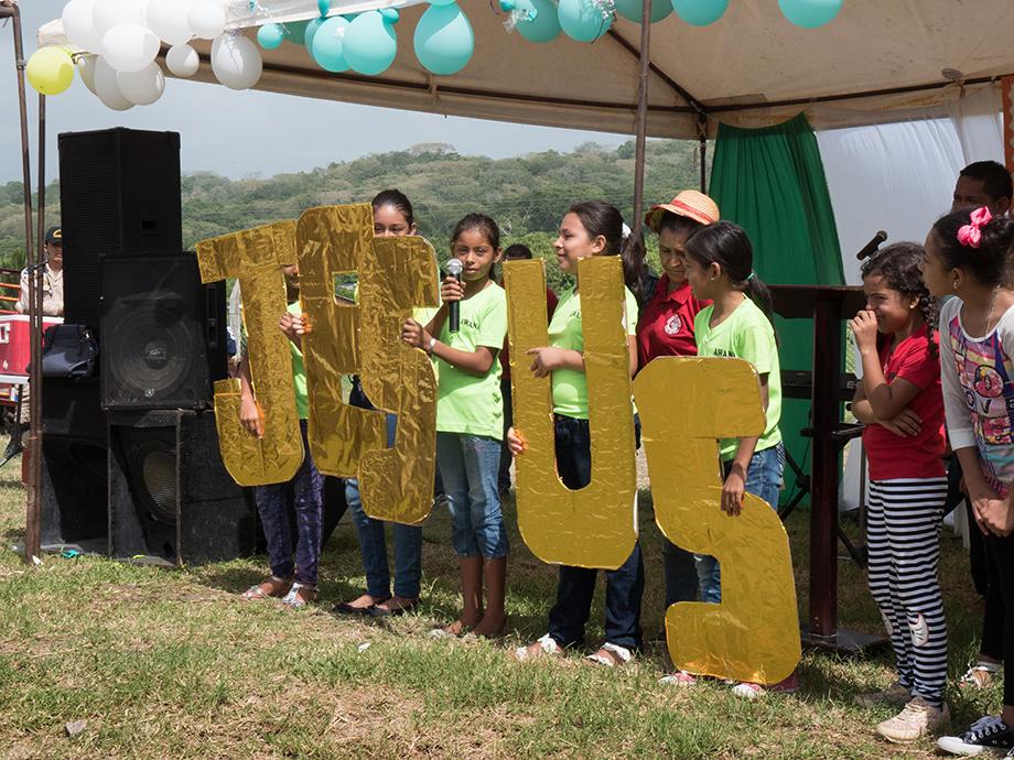 Children sang and read scripture behind large letters spelling out Jesus as part of the celebration of placing the cornerstone for Casa de Paz United Methodist Church. Photo by Kathy L. Gilbert.
