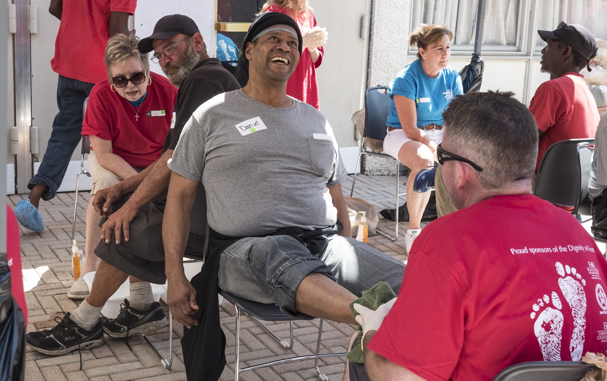 Daniel smiles as he gets his feet washed by a volunteer from Christ Church, a United Methodist congregation with campuses in Fort Lauderdale and Pompano Beach, Fla. Volunteers washed the feet of 189 homeless men and women on March 25, Palm Sunday. Each person walked away with two pairs of socks and new shoes. Photo by Kathy L. Gilbert, UMNS.