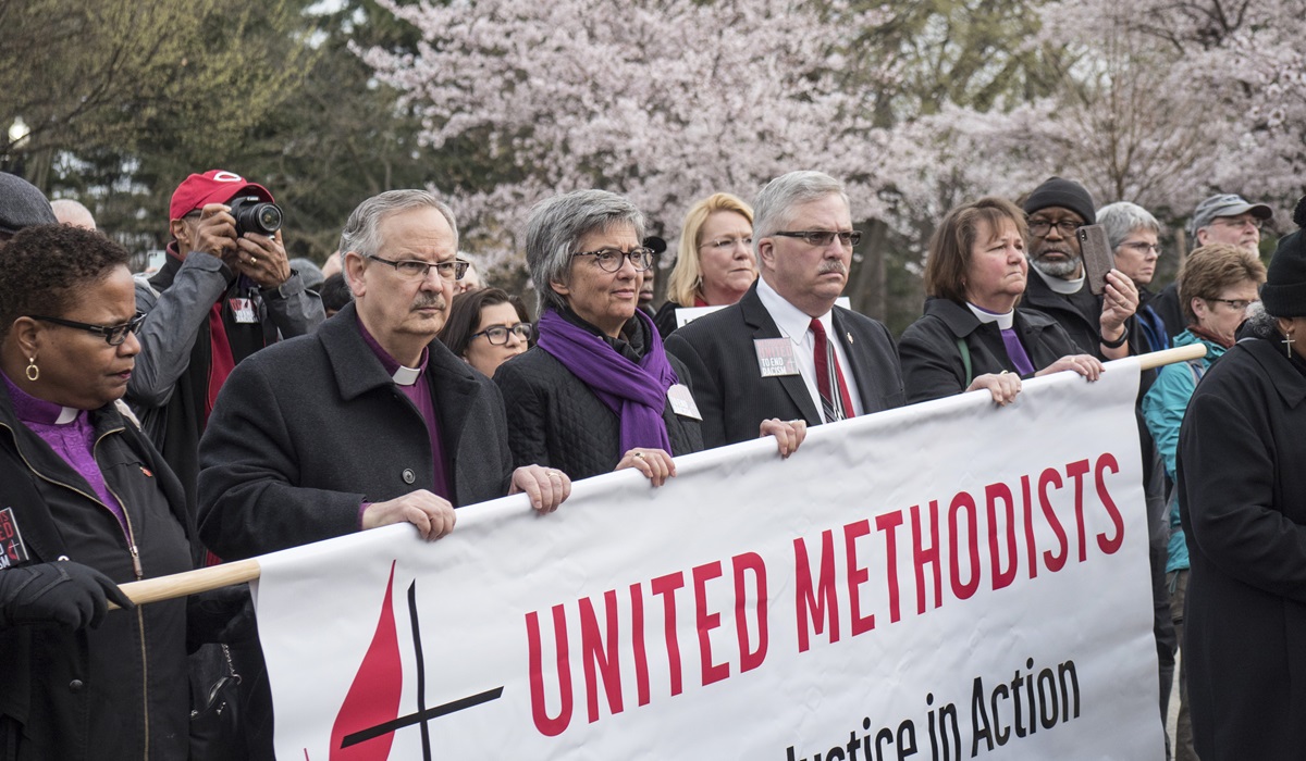 Bishops (from left) LaTrelle Easterling, Bruce R. Ough, Hope Morgan Ward, Bob Farr and Karen Oliveto carry a United Methodist banner. Photo by Kathy L. Gilbert, UMNS