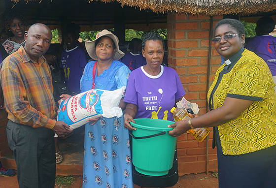 The Rev. Joseph Chimberengwa (from left), Old Mutare Station chairperson; Chenai Gwiriri, Harare East District evangelism chairperson; Cecilia Thobani, Fairfield Children's Home administrator; and the Rev. Tafadzwa Musona, acting district superintendent of the Harare East District, show off donations from United Methodist Women to The Fairfield Children’s Home in Zimbabwe. Photo by Kudzai Chingwe, UMNS.