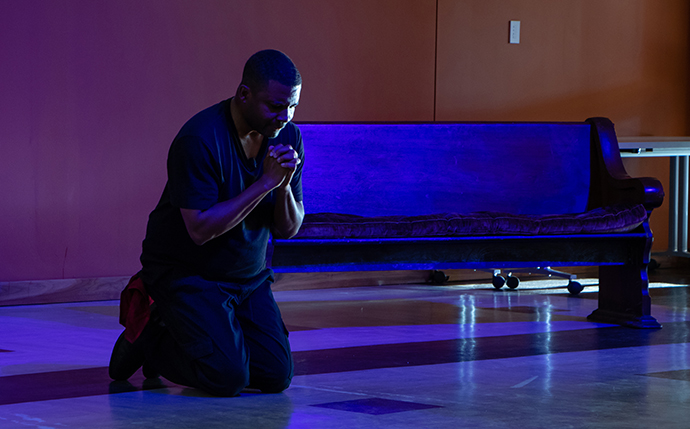 Playwright and actor Mike Wiley in a performance of his one-man play, “Blood Done Sign My Name,” during the April 12-14 meeting of the Board of Global Ministries. The play is based on the book by Timothy Tyson. Photo by Jennifer Silver, General Board of Global Ministries.