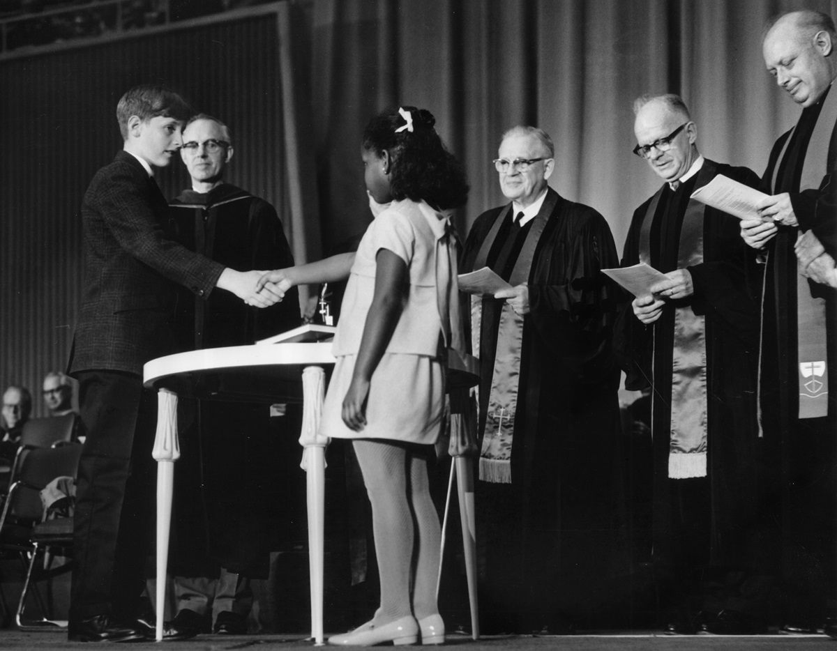 Robert O. Tupper II, representing the Evangelical United Brethren, and Rhonda Renfro, representing the Methodist Church, were the two children chosen to shake hands as part of the ceremony uniting the two denominations into The United Methodist Church, on April 23, 1968, in Dallas. Renfro, now 57, says event organizers wanted the symbolism of a black child and white child shaking hands to reinforce the new denomination’s commitment to racial reconciliation. Photo courtesy of the United Methodist Commission on Archives and History. 
