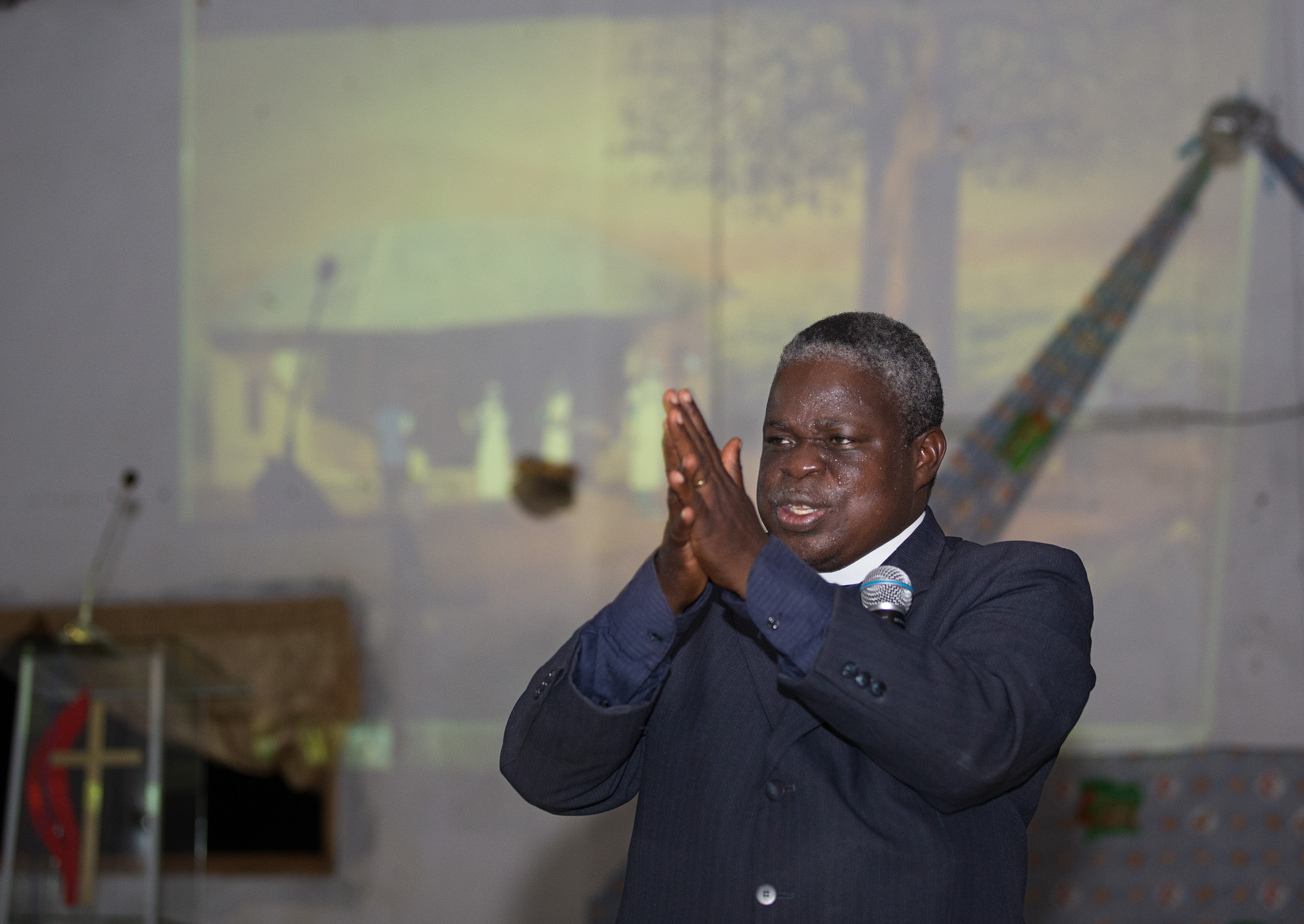 The Rev. Marcel Sachou demonstrates the proper technique for hand-washing while showing a video about the prevention of Ebola at the United Methodist Church in Sassandra. The animated video, “Ebola: A Poem for the Living,”  was created by Chocolate Moose Media and mobile-health-education innovator iHeed in collaboration with United Methodist Communications. 