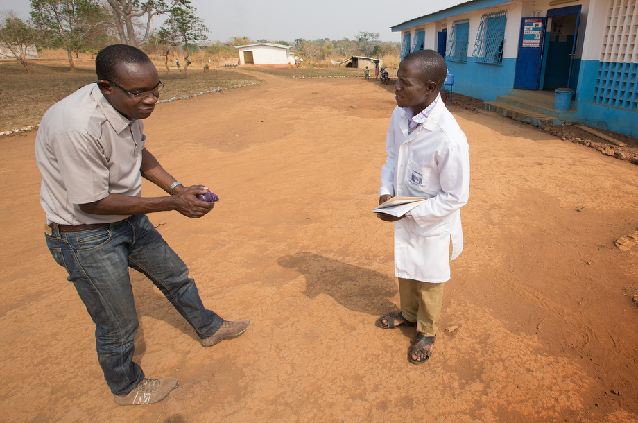 Dr. Simplice Adouko (left) bows in greeting to nurse Joelin Gba Nica at the Centre de Santé Urbain hospital in Sipilou, Côte d'Ivoire, along the border with Guinea. Polite bows have replaced handshakes in much of Côte d'Ivoire at the urging of health officials concerned about possible spread of the Ebola virus. 