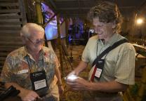 Eric Youngren (right) and John Macdonald view a solar-powered light during the Innovation Fair at the Game Changers Summit at the Opryland Hotel in Nashville, Tenn. Photo by Mike DuBose, UMNS.