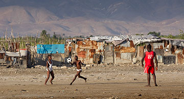 Children play soccer in the Cit Soleil slum of Port-au-Prince, Haiti.