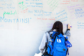 The wall holds notes that include Bible verses, Dr. Seuss quotes, Aerosmith lyrics and even drawings. Photo by John Rash.