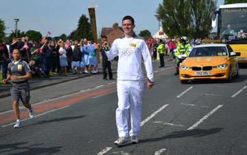 Olympic torchbearer Tom Clayton was nominated for the privileged task by his pastor, the Rev. Sue Pegg, at St. John's Methodist Church in Shieldfield, England. Photo by Mel Pegg.