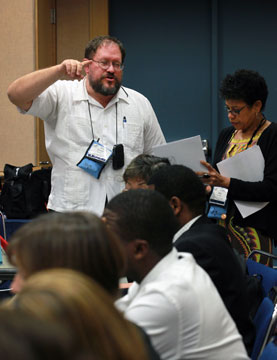 Donald Reasoner, General Conference staff, instructs a group of interpreters during the 2012 United Methodist General Conference in Tampa, Fla. To his right is Keila Guimaraes with the Portuguese language interpretation team.