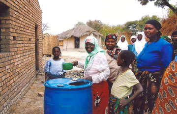 Women in Malawi observe a cleansing with water before prayer in the mosque.