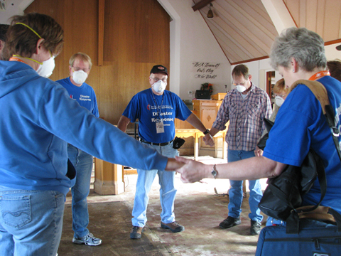Volunteers gather in prayer inside the sanctuary of Faith United Methodist Church in Minot, N.D., following the flooding of 2011. UMNS photos by Doreen Gosmire.