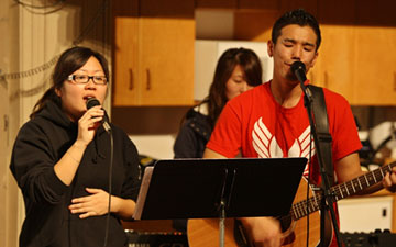Cindy Chang, left, sings during an event at Korean United Methodist Church in San Jose, where she is an active member and lay deacon. After growing up in the U.S., she is facing deportation to Korea.