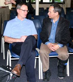 The Rev. Adam Hamilton (left) speaks with Neil M. Alexander before a report on the Call to Action effort to the Council of Bishops. Hamilton and Alexander are members of the Interim Operations Team, a group of clergy and laity charged with building on the Call to Action recommendations.