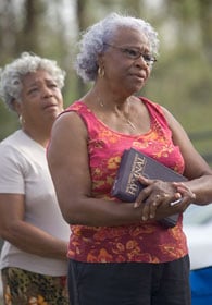 Atha Brown (right) and Victoria Alfred sing during an outdoor worship service in Slidell, La., in 2005. A UMNS file photo by Mike DuBose.