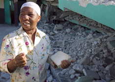 Noel Zierne shows where she was trapped in the rubble of the church following the earthquake.