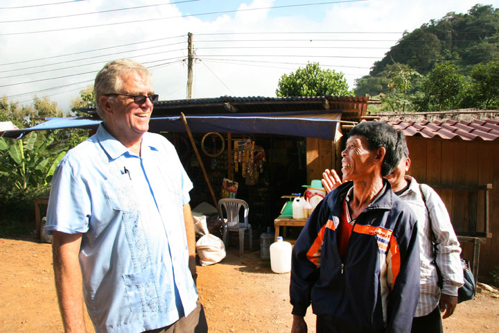 The Rev. Clinton Rabb visits with a church member after worship near Luang Prabang, Laos, in September 2008. A UMNS photo by Adam Neal, GBGM.
