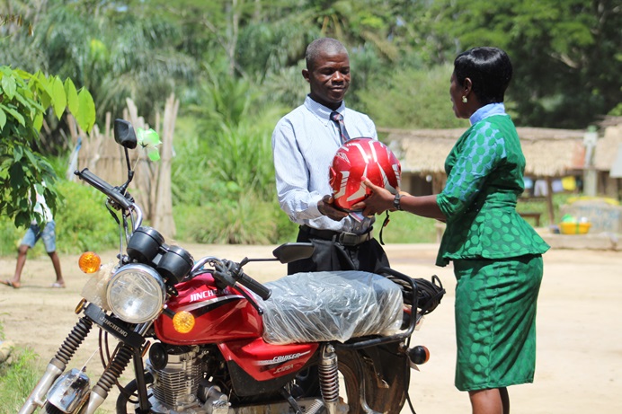 The Rev. Cecelia Marpleh, district superintendent for the Liberia Conference, presents a motorbike to Pastor William Kulah for his travels to Gbanjuloma United Methodist Church each week. With the motorbike, it takes him five hours to get to his assigned church. Photo be E Julu Swen, UMNS. The Rev. Cecelia Marpleh, district superintendent for the Liberia Conference, presents a motorbike to Pastor William Kulah for his travels to Gbanjuloma United Methodist Church each week. With the motorbike, it takes him five hours to get to his assigned church. Photo be E Julu Swen, UMNS.