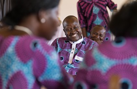 Jonas Assogba (center) grins as he tries to answer a question during a church version of the newlywed game at Nazareth United Methodist Church in Abidjan, Côte d'Ivoire. The game marked the completion of a three-and-a-half month course on marriage. Photo by Mike DuBose, UMNS.