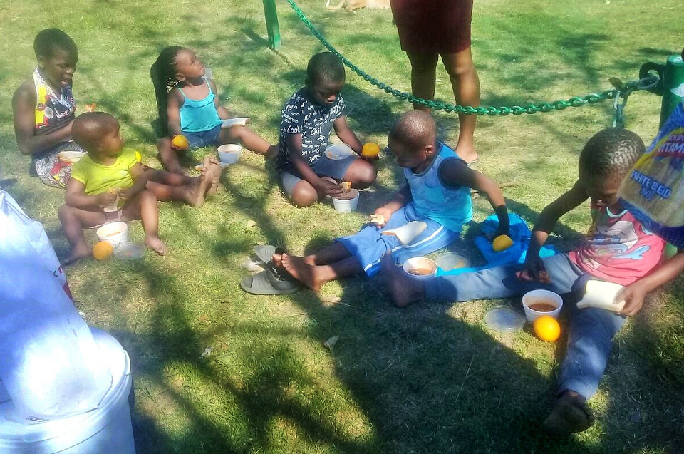 Children from Clermont Township in Durban, South Africa, enjoy a nutritious meal at a soup kitchen operated by members of the United Methodist Young Adult Organization. Photo by Nandipha Mkwalo, UMNS.