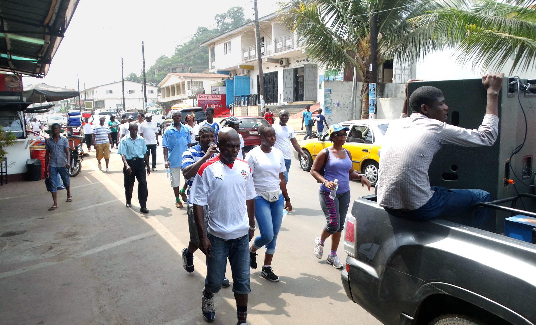 Men of Bishop Baughman United Methodist Church, supported by the church’s women and other men’s groups, walk across western Freetown, Sierra Leone, sharing messages of peace and reconciliation with the aid of a microphone and speaker. After bitterly fought elections left Sierra Leone divided along tribal and regional lines, the men wanted to evangelize in new ways to help bring the country together. Photo by Phileas Jusu, UMNS.