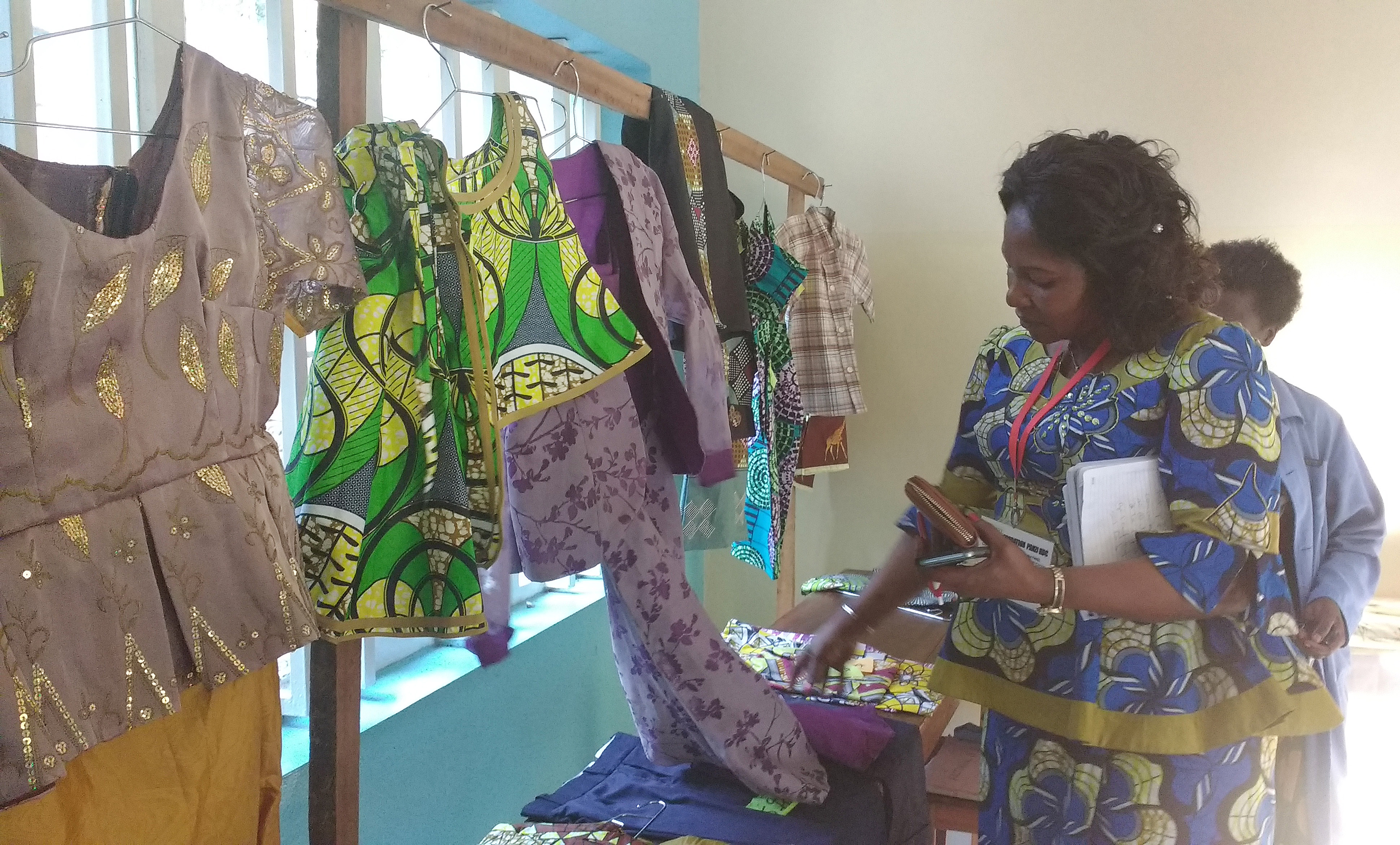 Dr. Marie Claire Manafundu, head of the Mama Lynn Center and wife of East Congo Area Bishop Gabriel Yemba Unda, examines clothing at the Panzi Foundation in Bukavu, Democratic Republic of Congo, where victims of rape are able to learn a trade such as sewing to help support themselves. Photo by Philippe Kituka Lolonga, UMNS.