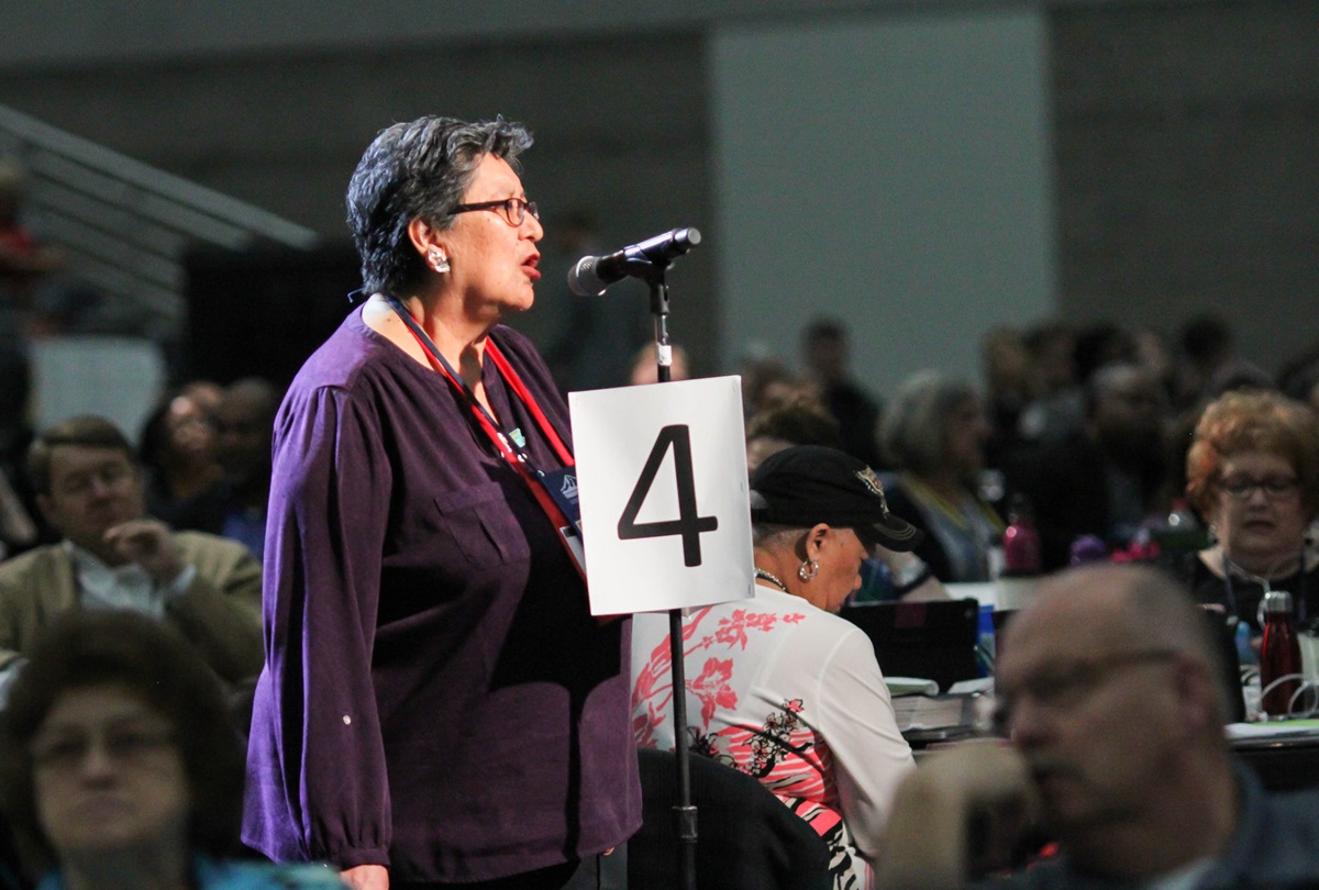Cynthia Kent, chairperson of the Native American International Caucus, speaks on a petition that asks The United Methodist Church “to be intentional about raising awareness of the harm caused by some sports teams through the use of mascots and/or symbols promoting expressions of racism and disrespect of Native American people," during the May 19 plenary session of the 2016 General Conference in Portland, Ore. Photo by Maile Bradfield, UMNS. Cynthia Kent, chairperson of the Native American International Caucus, speaks on a petition that asks The United Methodist Church “to be intentional about raising awareness of the harm caused by some sports teams through the use of mascots and/or symbols promoting expressions of racism and disrespect of Native American people," during the May 19 plenary session of the 2016 General Conference in Portland, Ore. Photo by Maile Bradfield, UMNS.