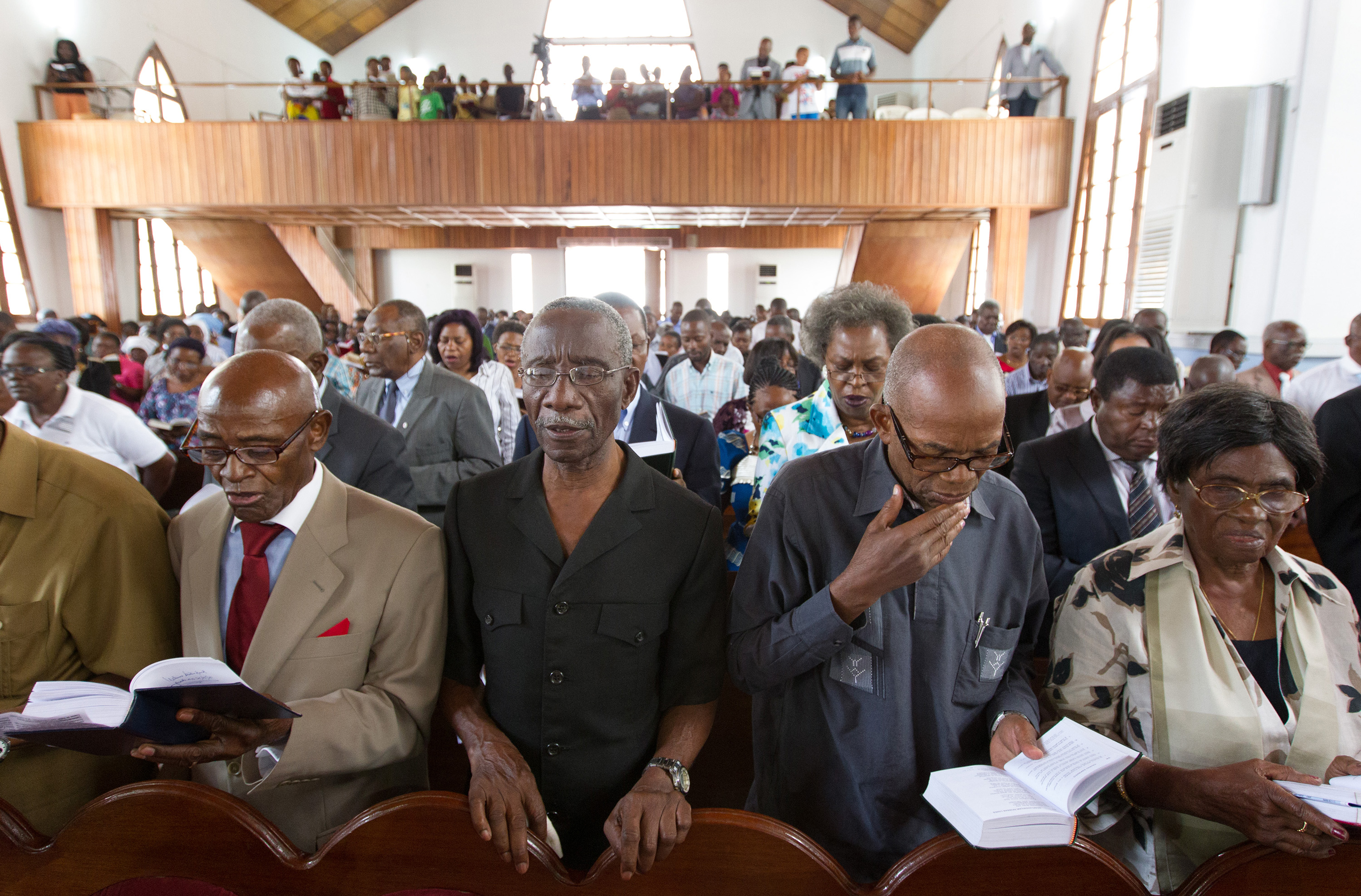 Parishioners read responsively during worship at Central United Methodist Church in Luanda, Angola, in 2012. The Eastern Angola conference has added a statistician to their staff to better evaluate the progress of the church. File photo by Mike DuBose, UMNS.