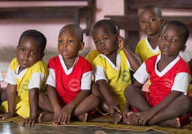 Children listen to a vocabulary lesson at the Bethlehem Day Care center in Youhoulil, Côte d'Ivoire. The United Methodist women’s organization in the Dabou District started the program in 2016 to help provide nutrition and education for the children of local farmers. Photo by Mike DuBose, UMNS.