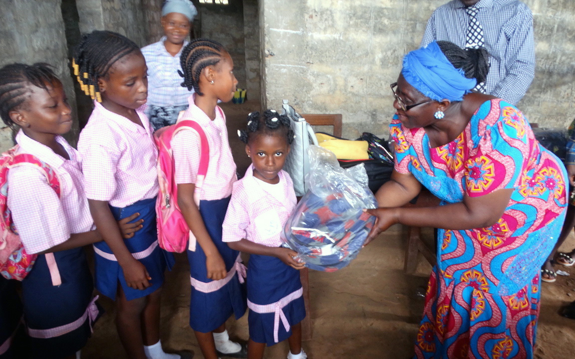 Ethel Sandy, Sierra Leone Conference women’s coordinator, passes out school supplies to children at Hope Preparatory School in Kamayama, Sierra Leone, in June, one of four United Methodist schools affected by the August 2017 landslide and flooding. Photo by Phileas Jusu, UMNS. 