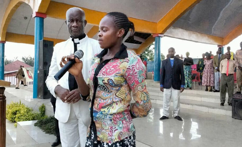 Rachel Fatuma testifies about what God has done in her life during an evangelization campaign led by the Rev. Martin Kasongo (left) in Kindu. Fatuma joined The United Methodist Church during the event. Photo courtesy of the Rev. Martin Kasongo.