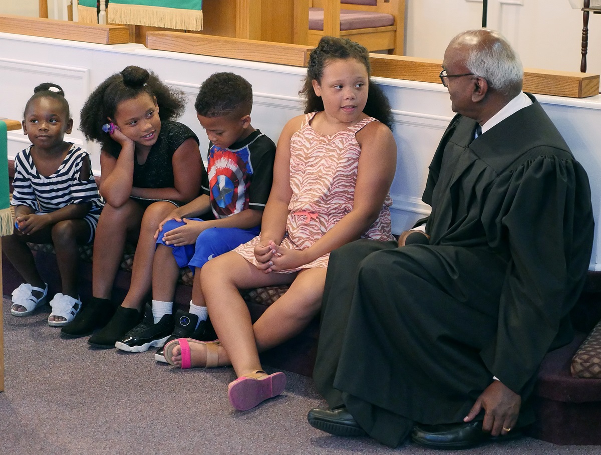 The Rev. Moses Kumar shares a children’s sermon on July 8, his second Sunday as pastor of Lillard Chapel United Methodist Church in Murfreesboro, Tennessee. The top executive of the denomination’s finance agency, he is also a newly licensed local pastor. Photo by Heather Hahn, UMNS. The Rev. Moses Kumar shares a children’s sermon on July 8, his second Sunday as pastor of Lillard Chapel United Methodist Church in Murfreesboro, Tennessee. The top executive of the denomination’s finance agency, he is also a newly licensed local pastor. Photo by Heather Hahn, UMNS.