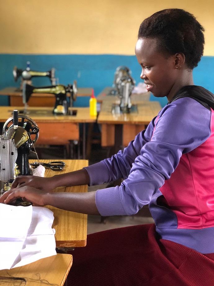 Rose Uwanmugira, a young adult in the Rwanda Provisional Conference, is studying tailoring with a grant from the Center for Health and Hope. Funds were raised by Rev. Tom Owens, a United Methodist pastor in Asheville, N.C., a year ago when he and friends ran a marathon up the 14,000-foot Pikes Peak in Colorado Springs, Colo. Photo by Donald E. Messer.