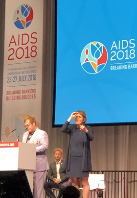 Singer and AIDS activist Elton John speaks during the 2018 International AIDS Conference in Amsterdam as Prince Harry, Duke of Sussex, sits in the background. The two are collaborating on a new HIV/AIDS campaign aimed at reaching young men. Photo by Donald E. Messer.