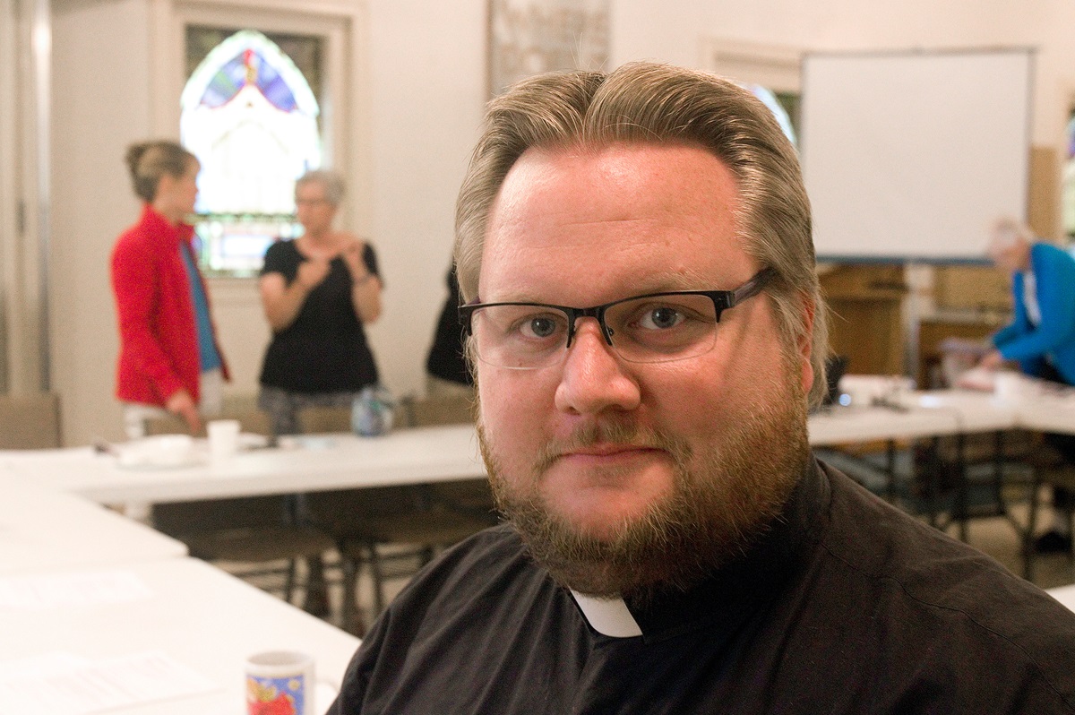 The Rev. Phil Woodson, associate pastor for outreach and witness at First United Methodist Church in Charlottesville, Va., attends a Charlottesville Clergy Collective meeting on July 25, 2018, at Mt. Zion First African Baptist Church. The interfaith group has continued to respond after a white supremacist rally and counter protest in Charlottesville turned deadly on Aug. 12, 2017. Photo © Richard Lord The Rev. Phil Woodson, associate pastor for outreach and witness at First United Methodist Church in Charlottesville, Va., attends a Charlottesville Clergy Collective meeting on July 25, 2018, at Mt. Zion First African Baptist Church. The interfaith group has continued to respond after a white supremacist rally and counter protest in Charlottesville turned deadly on Aug. 12, 2017. Photo © Richard Lord