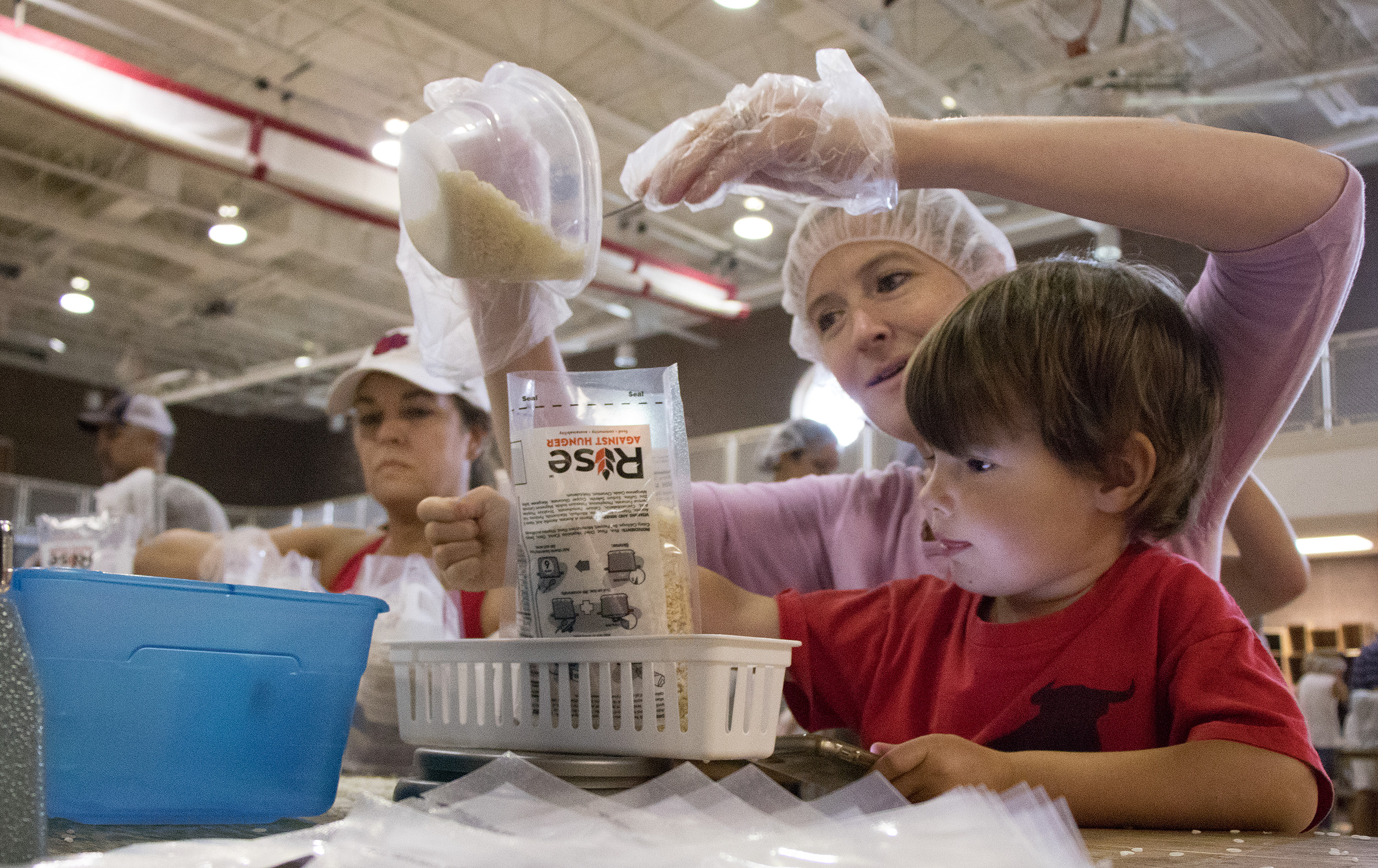 The ability for all generations to help pack meals for Rise Against Hunger is appealing to congregations like Dunwoody United Methodist Church, as demonstrated at last year’s “Foodstock” event. The metro Atlanta congregation has assembled more than 2 million meals since 2012 for the ministry. Photo by Bryan Jordin, Overtone.
