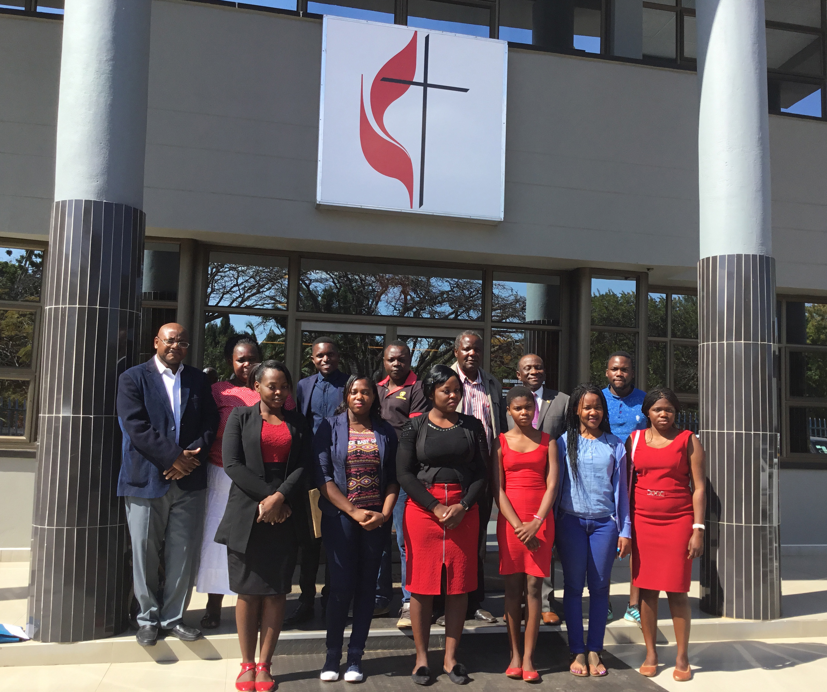 Beneficiaries of tuition aid from the Balm in Gilead Ministry gather for a photo with the Rev. Abiot Moyo in Harare, Zimbabwe, during his recent visit. Moyo is pastor of Harbour United Methodist Church in Scituate, Massachusetts. Photo by Chenayi Kumuterera, UMNS.
