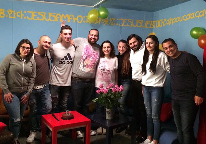 The Rev. Anna Shammas (center) joins with Arabic-speaking youth and young adults for Bible study, games and dinner on Tuesdays at the United Methodist church in Aarau, Switzerland. Photo courtesy of Bishop Heinrich Bolleter.