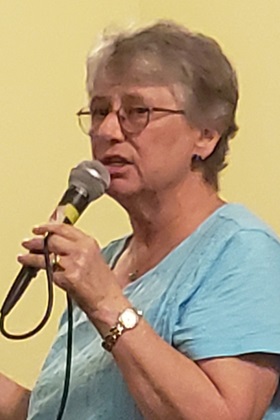  July 31, 2018 photo of Mary Ellen Kris, speaking with members of her church regarding her recent experience immigrant women and children detained at the SW Texas Family Residential Center in Dilley, Texas. Photo courtesy of Julia R. Tulloch, Church of St. Paul & St. Andrew, NYC. 