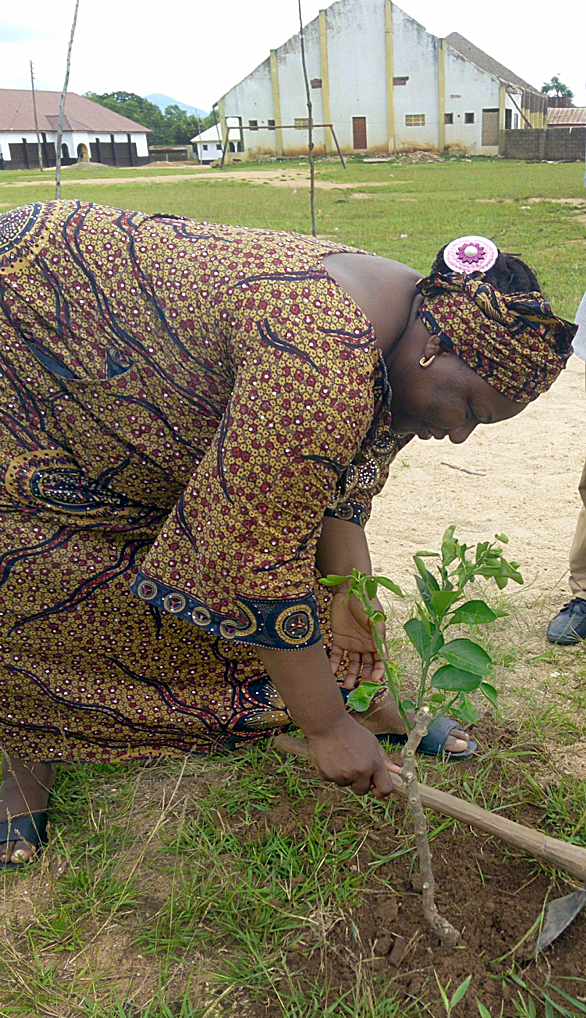 Mary Jonathan plants an orange tree at a United Methodist orphanage in Jalingo, Nigeria, with the anticipation that the fruit will supplement diets in the future. Photo by Sharon Adamu Bambuka, UMNS. 