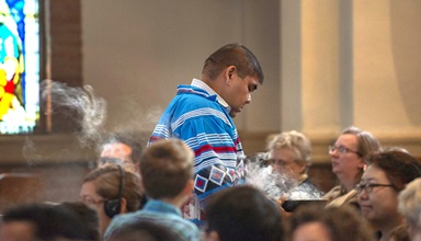 The Rev. Chebon Kernell walks through the sanctuary at Grace United Methodist Church in Atlanta offering incense during the closing worship service for Global Ministries.  Photo by Hector Amador.  The Rev. Chebon Kernell walks through the sanctuary at Grace United Methodist Church in Atlanta offering incense during the closing worship service for Global Ministries.  Photo by Hector Amador.