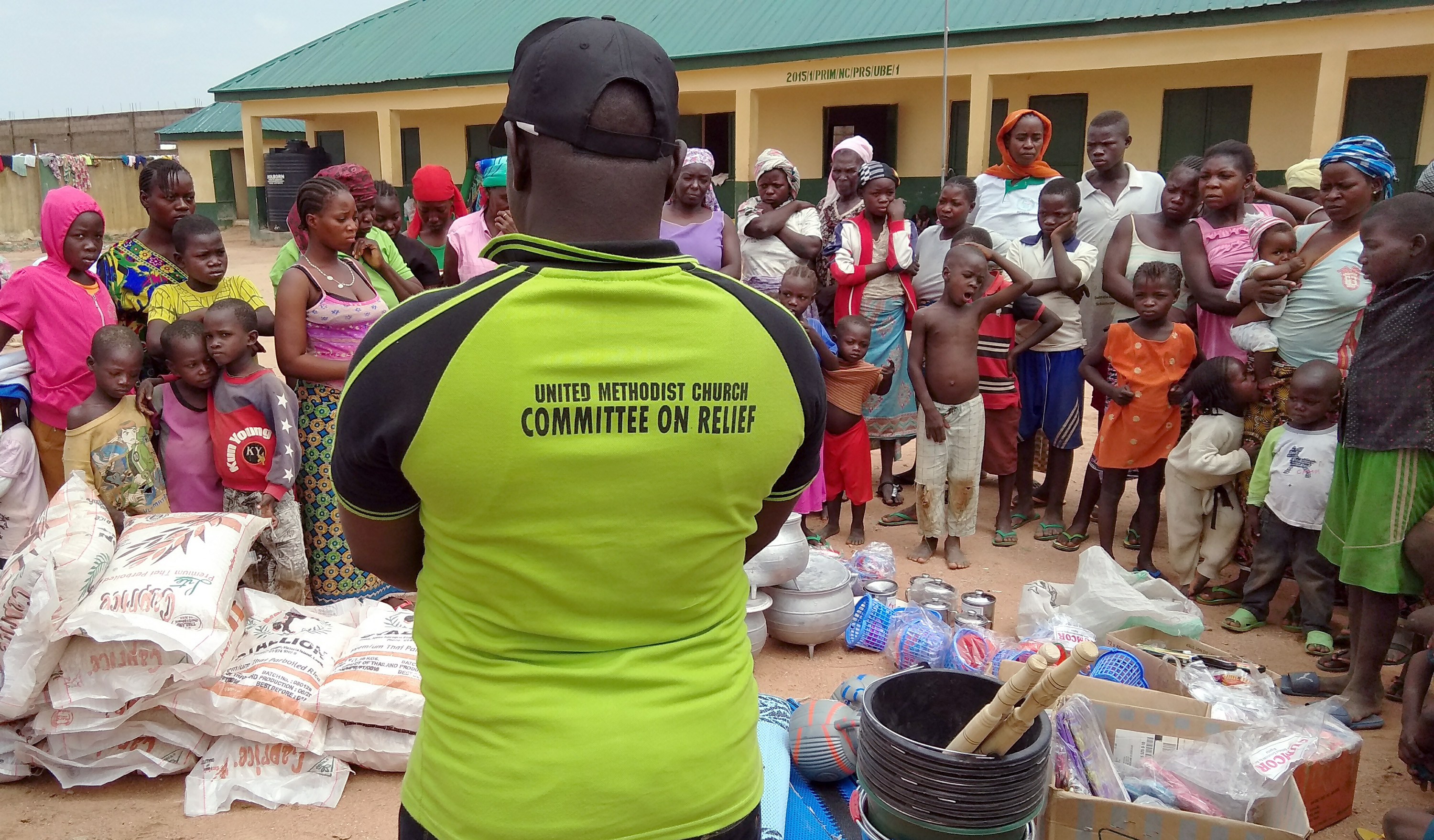 Families displaced by attacks from Fulani herdsmen and the Boko Haram terrorist group line up for relief supplies and medical attention at a camp for internally displaced persons in Numan, Nigeria. Photo by the Rev. Ande I. Emmanuel.