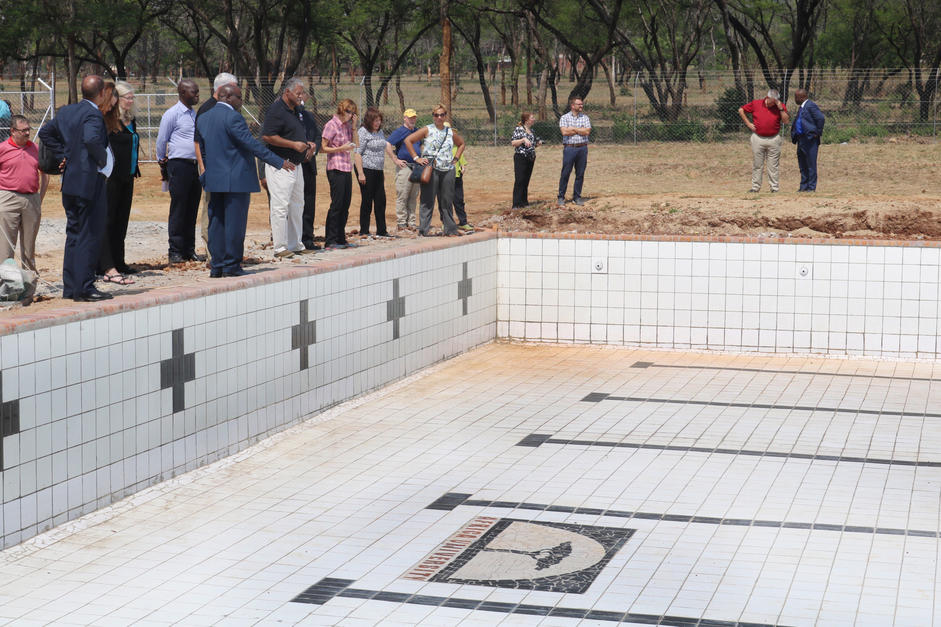 Attendees of the recent Africa University board of directors meeting view the progress of a new university swimming pool funded by the Baltimore-Washington Conference. Photo by Eveline Chikwanah, UMNS.