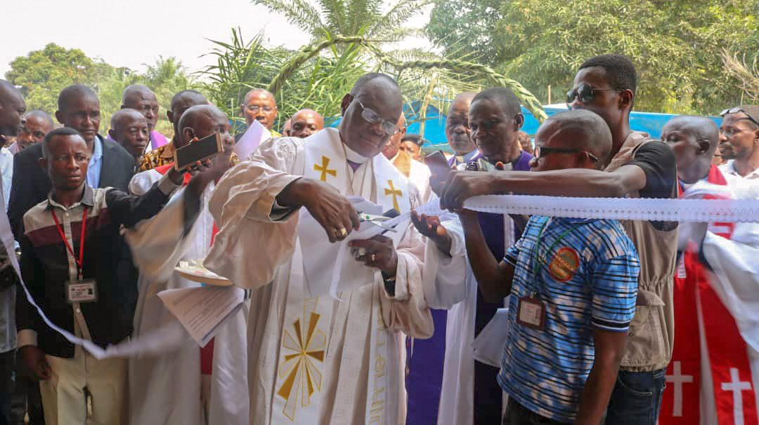 Bishop Gabriel Yemba Unda cuts the ribbon during the inauguration of the new medical center in Okasa village. Photo by Chadrack Tambwe Londe, UMNS