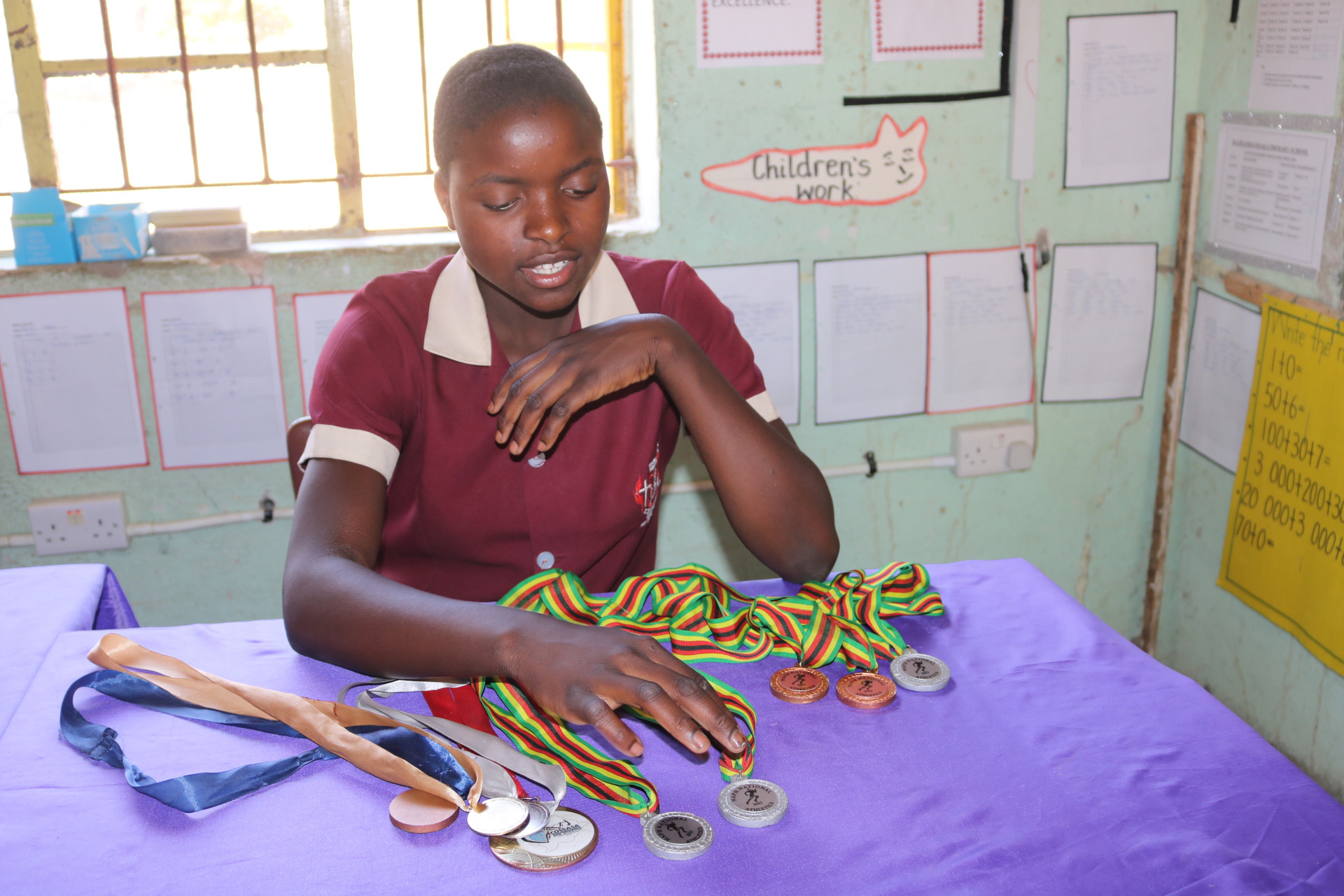 13-year-old Ngaakudzwe Katsvairo displays her medals from both local and international track and field competitions. Katsvairo attends The United Methodist Church’s Mashambanhaka Central Primary School in Zimbabwe. Photo by Eveline Chikwanah, UMNS. 