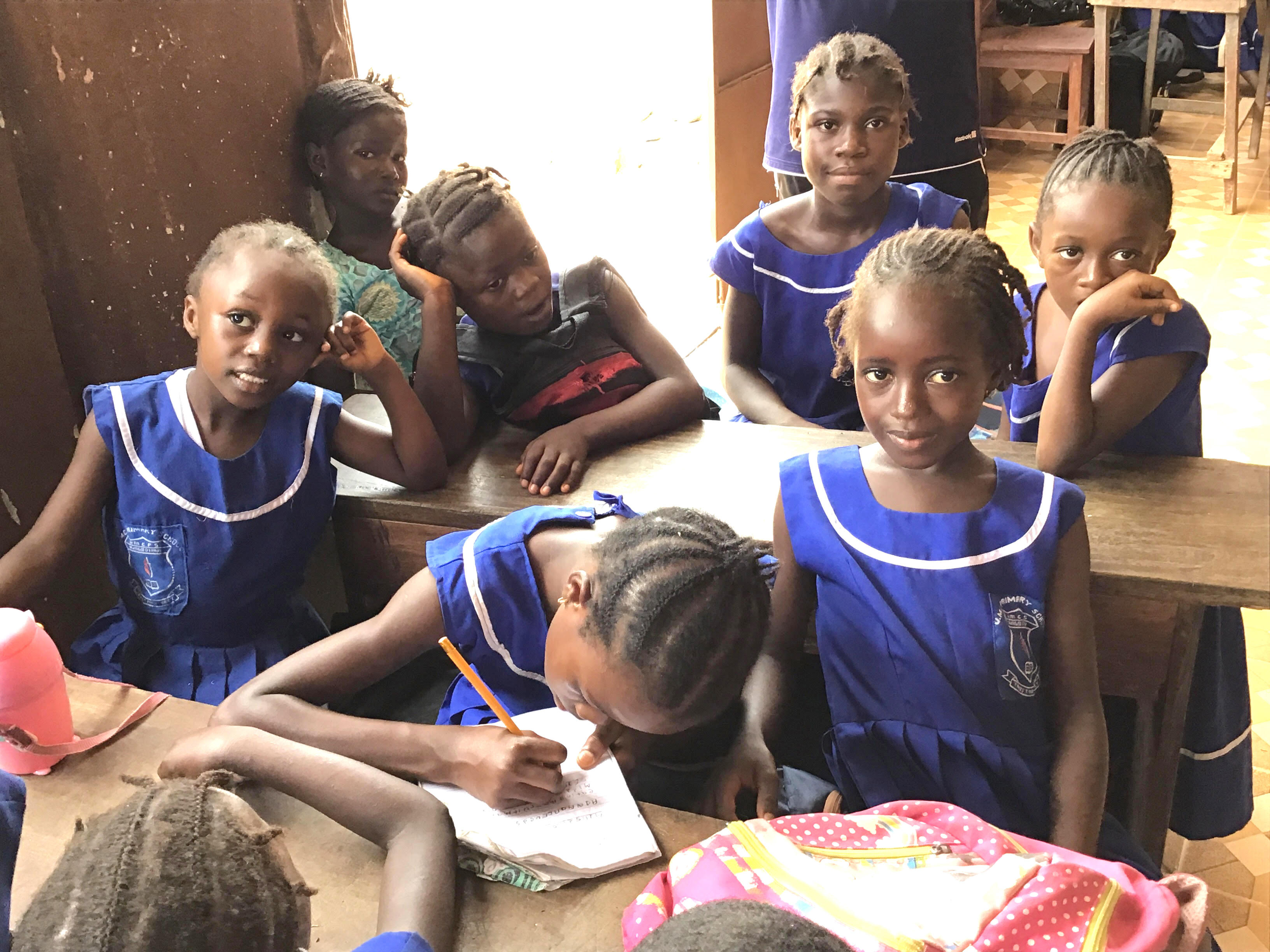 Students at the United Methodist Church Primary School in Njagboima, a community in the city of Bo, Sierra Leone, have temporarily relocated to the porch of the Rogers Memorial United Methodist Church due to unusually high admissions following the government’s free education policy.  Photo by Phileas Jusu, UMNS. 