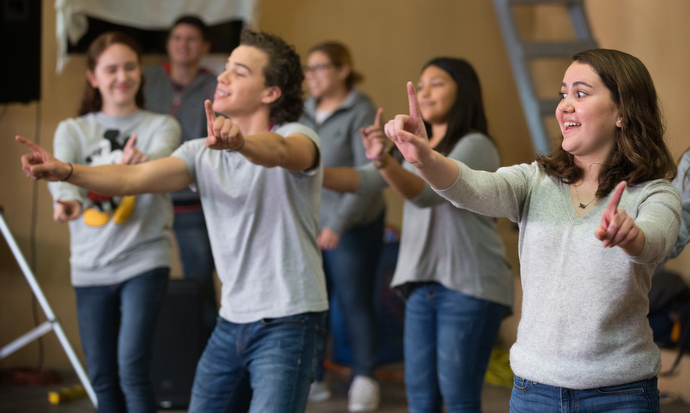 Youth from Nuevo Pacto Methodist Church lead a dance during the Christmas party.