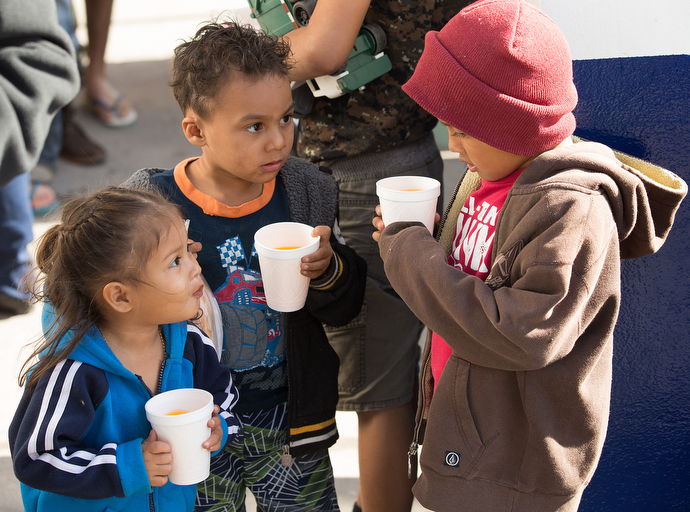 Migrant children enjoy a cold drink while they wait for a meal at El Divino Redentor Methodist Church.