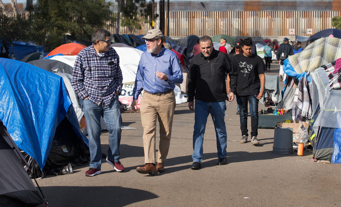 Bishop Felipe Ruiz Aguilar (left) of the Methodist Church of Mexico, the Revs. Jack Amick (center) of the United Methodist Committee on Relief and Edgar Avitia Legarda of the United Methodist Board of Global Ministries survey a makeshift camp for migrants outside the Benito Juarez sports complex.