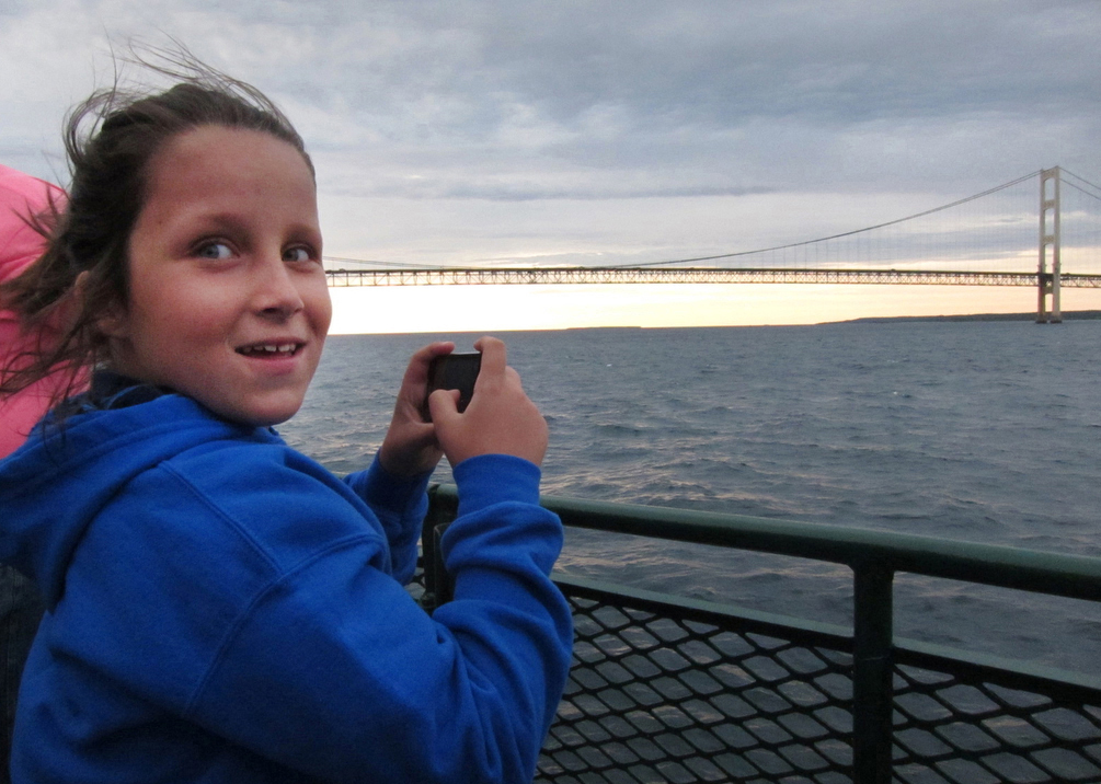 St. Ignace United Methodist Church's Allison Colegrove celebrates her 10th birthday riding the evening Vesper Cruise, which travels in the Straits of Mackinac and beneath the Mackinac Bridge. 