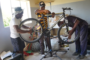 Gedion Mawoneke, Benjamin Dhliwayo and Damion Mutinhiri assemble a bicycle. United Methodist Church’s St. John’s Circuit in Mutare, Zimbabwe, is helping those in the Deaf community learn skills through the Holy Bike Sales project. Photo by Kudzai Chingwe. Gedion Mawoneke, Benjamin Dhliwayo and Damion Mutinhiri assemble a bicycle. United Methodist Church’s St. John’s Circuit in Mutare, Zimbabwe, is helping those in the Deaf community learn skills through the Holy Bike Sales project. Photo by Kudzai Chingwe.